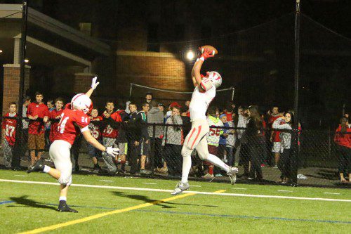 SENIOR WR Chris Calnan (right) goes up to catch the two-point conversion pass after Wakefield’s first touchdown of the game. Calnan also caught the TD pass from 25 yards away. (Donna Larsson Photo)