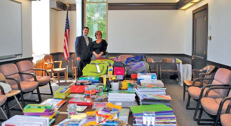 CHRIS CINELLA and Pam Pescatore of Edward Jones Investments with items donated in their summer school supplies drive.