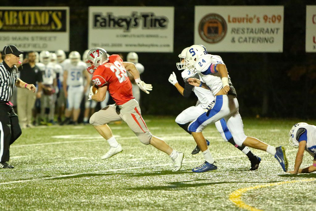 LUKE MARTIN, a senior RB (#28), gained 222 yards on 16 carries and scored all four Warrior touchdowns in Wakefield’s 27-0 triumph over Stoneham on Friday night at Landrigan Field.   (Donna Larsson Photo)