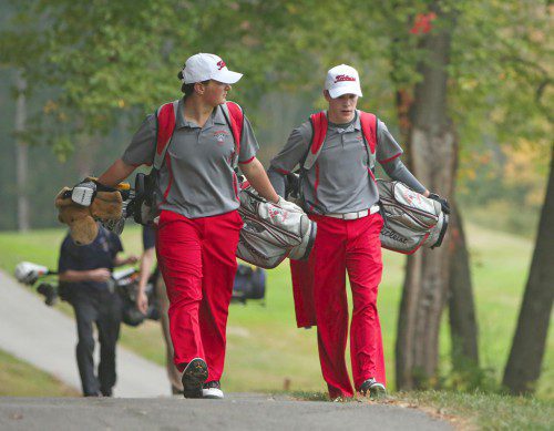 DAVID MELANSON (left) and Mike Guanci walk along the course at the Thomson Country Club during a recent match. Both came up with big victories yesterday at the number two and three positions against both Belmont and Watertown in a Warrior sweep of the tri-match. (Donna Larsson File Photo)