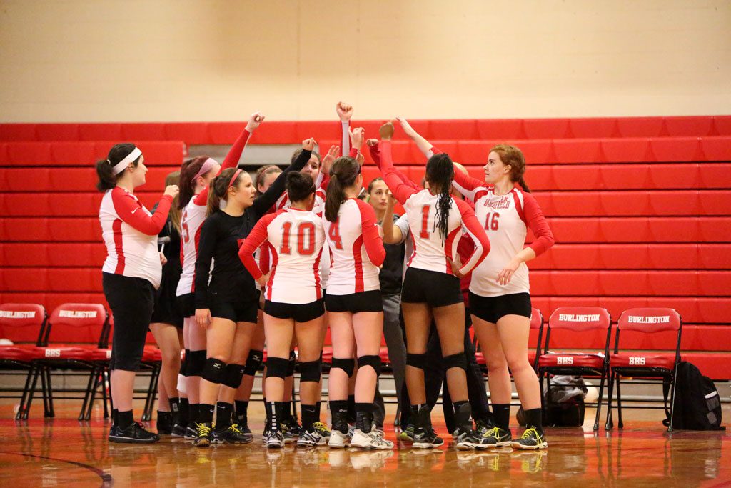 THE WMHS girls’ volleyball team high-fives each other during a recent match to rally the squad. The Warriors hosted Austin Prep last night at the Charbonneau Field House and were blanked 3-0 in a non-league match. (Donna Larsson File Photo)
