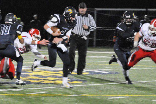 CAPT. Dan Sullivan (2) picks up 30 of his 180 yards rushing against Saugus. He also scored a TD in the playoff win.     (Jack Schnelle Photo)