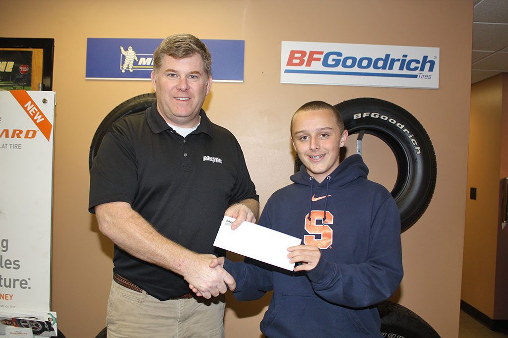 ALBION STREET resident Brett Maloney (right) receives his weekly prize from Jim Fahey of Fahey’s Tire Center. Maloney was the Week 7 winner of the 53rd annual Daily Item Football Contest with a 9-2 record and won out in a two-way tiebreaker. Maloney also was the Week 5 winner as well with a 9-2 record. Check out the Daily Item Football Contest each week for 11 weeks during the fall season. This week’s picks are on Pages 6 and 7. (Maureen Doherty Photo)