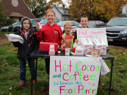 STUDENTS AT THE Greenwood Elementary School are raising money for the Wakefield Interfaith Food Pantry by running a “Helping with Hot Chocolate” stand outside of the Most Blessed Sacrament Parish today. Over $70 was raised this morning and the stand will be open from 3 this afternoon to 8 tonight at the Precinct 4 polling place. Stop by on your way to vote and buy a cup of coffee or hot chocolate to help families in need this holiday season. Pictured from the left are Caleb Fowler, Alexandra Baldwin, Will Baldwin and Luke Greif.