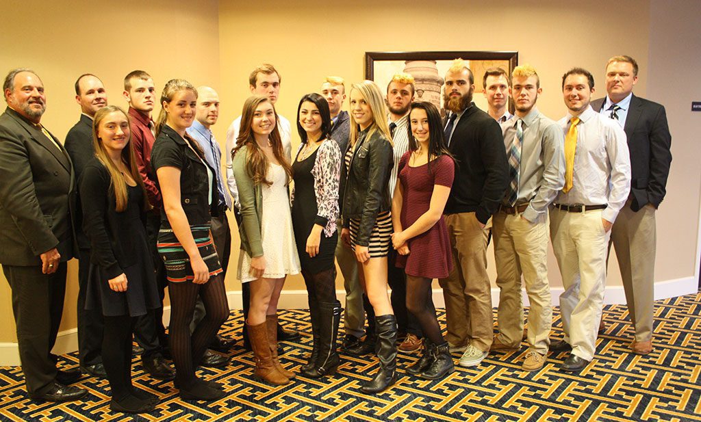THE RIVALRY between the Pioneers and Hornets was replaced with amity while the captains of both teams were guests of honor during the pre-Thanksgiving luncheon sponsored by the Lynnfield and North Reading Rotary Clubs Nov. 20. Front row, from left, North Reading drum major Ashtyn Parker–McDermott, North Reading color guard captain Annie Nitzsche, North Reading cheerleading captain Mackenzie Sturdevant, North Reading cheerleading captain Mikayla DiPlatzi, Lynnfield cheerleading captain Alexa Distefano, Lynnfield football captain Cam Rondeau and Lynnfield band president Paul DiRico. Back row, from left, North Reading band director Eric Forman, North Reading football coach Jeff Wall, North Reading football captain Austin Bradley, North Reading football captain Cole Hughes, North Reading football captain Nic O’Connell, Lynnfield football captain Jonathan Knee, Lynnfield football captain Dan Sullivan, Lynnfield football captain David Adams, Lynnfield band director Tom Westmoreland and Lynnfield football coach Neal Weidman. (Dan Tomasello Photo)
