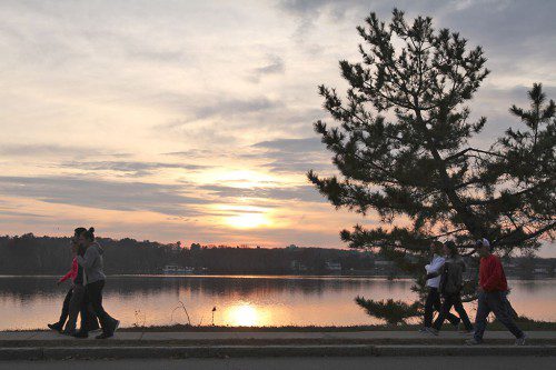 DAYLIGHT BEGINS to fade yesterday as walkers take advantage of great late November weather. (Donna Larsson Photo)