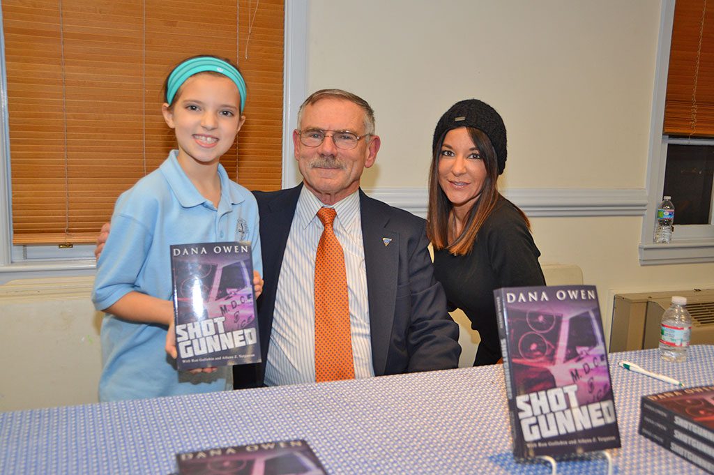 "SHOTGUNNED" author Dana Owen, recently talked to residents and held a book signing at the Flint Memorial Library, where he met Gianna Ciampa (left) and Diane Barabino.  (Bob Turosz Photo)
