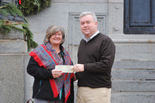 ROTARY CLUB President Mary Beth McAteer-Margolis presents an Emergency Fund donation to Mayor Robert J. Dolan.