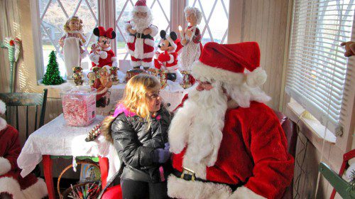 LITTLE Lila Vezina, 4, of Melrose came to see Santa Claus at his headquarters on Veterans Memorial Common last Saturday. Santa’s headquarters will continue to be open this coming weekend from 1 to 5 p.m. and weekdays from 3:30 to 7 p.m., beginning tomorrow. (Gail Lowe Photo)