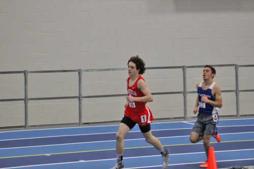 ADAM ROBERTO, a sophomore (left), won the mile with a state qualifying time of 4:45.30 in Wakefield’s 56-30 triumph over Wilmington on Tuesday night at Boston University.