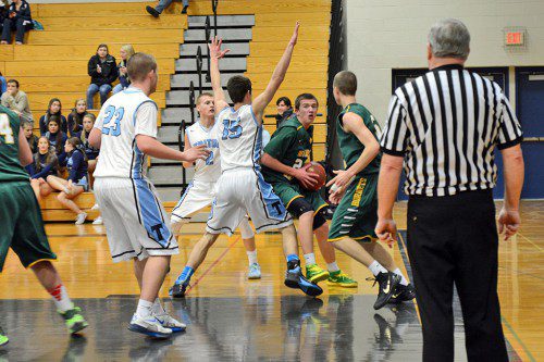 JUNIOR ADAM GOLDSTEIN, (center), looks for room in back and forth competition against Triton on the road. The Hornets earned a much needed 60 to 56 win against the Vikings. (Deanna Castro Photo)