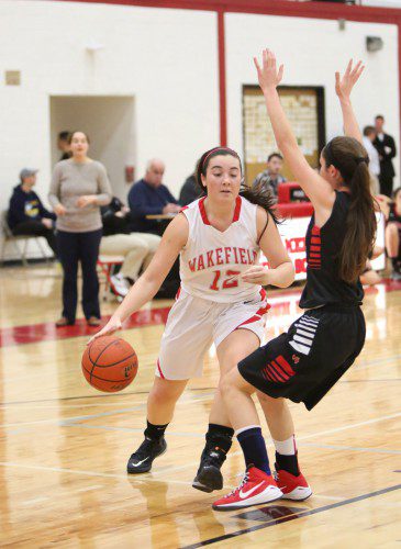 GABBY JOLY,  a junior forward (#12), drives to the basket during a recent contest. Joly scored four points in makeup game against Belmont last night. The Warriors dropped a 51-30 contest. (Donna Larsson File Photo)