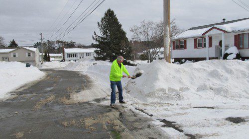 OLD COLONY DRIVE resident Bill Wladkowski has been proactive in shoveling snow off his roof. Many homeowners are experiencing water leaks and other damage to their homes due to heavy snow accumulation. Wladkowski is also a good neighbor to many. He is shown here helping to clear his neighbor’s driveway. (Gail Lowe Photo)