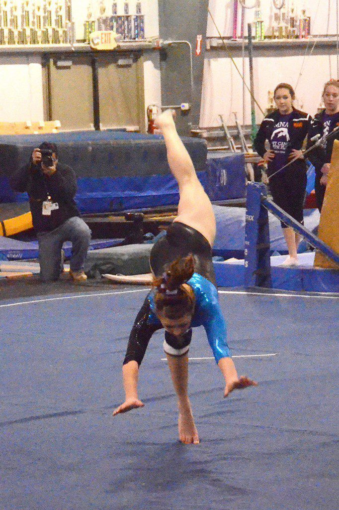 NORTH READING'S JULIA VALENTI (shown above in the floor exercise) led the way in the co–op gymnastic's tri–meet victory. (John Friberg Photo)
