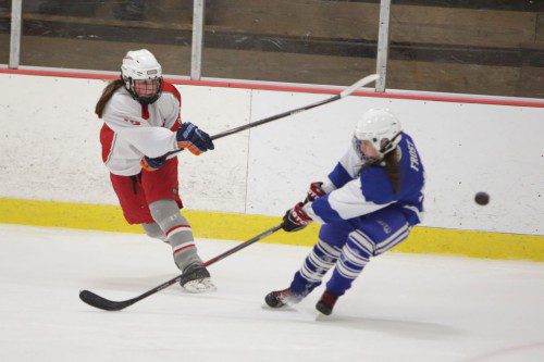 COURTNEY HILL, a freshman defenseman (#3) shoots the puck past Stoneham’s Alexandra Frost. Hill assisted on one of the two goals as Wakefield played Stoneham to a 2-2 tie. (Donna Larsson Photo)
