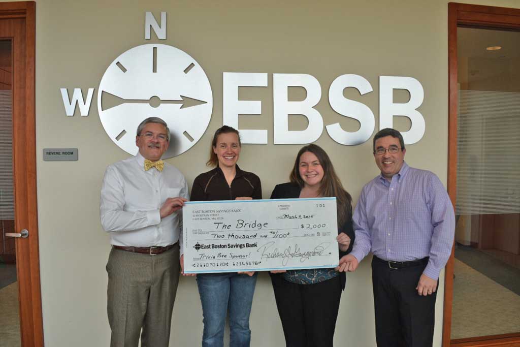 ERIC HEATH, senior vice president (left) and John Carroll, chief operating officer (right) at East Boston Savings Bank (EBSB), present a check for $2,000 to Melisaa Ripley (second from the left), president of the Board of Directors of The Bridge: A School Community Partnership, and Jennifer McAllister, The Bridge’s coordinator of volunteers. EBSB’s support allows all monies raised at the annual Adult Trivia Bee to go to The Bridge’s volunteer program in the Melrose Public Schools. The Bee will be held at Memorial Hall on Saturday, March 28, at 7 p.m. For information call 781-979-2299.