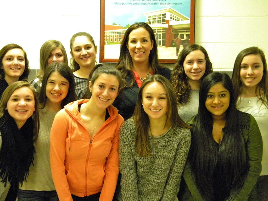 MOTIVATIONAL SPEAKER Cara Filler (center) returned to Lynnfield High School on March 19, where she discussed the dangers of reckless driving and outlined ways to prevent it with LHS sophomores and juniors. Front row, from left, Hannah Scollard, Danielle Douglas, Amanda Sieger, Renee DelNegro and Karan Singh. Back row, from left, Lexi Yannone, Rebecca Simonetti, Rachel DiTullio, Filler, Brianna Weir and Sarah Mezini.  (Dan Tomasello Photo) 