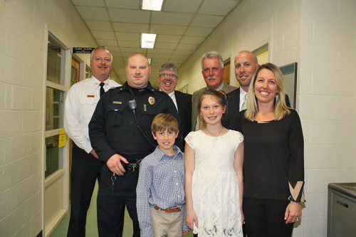 MARBLEHEAD Detective Brendan Finnegan was hailed as a hero for saving Patrolman Jared Provost's life during a choking incident at Patrolman Charlie Peabody's retirement party last month. Clockwise from left: Lynnfield Police Chief Dave Breen, Patrolman Provost, Marblehead Police Chief Robert Picariello, retired Patrolman Charlie Peabody, Detective Finnegan, his wife Jen and their children, Lily, 11, and William, 10. (Maureen Doherty Photo)