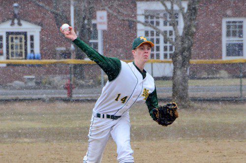 ONLY IN NEW ENGLAND. Hornet pitcher Greg Johnson delivers as the snowflakes fall in North Reading’s first game of the season, a 7–4 loss to Bedford. (John Friberg Photo)