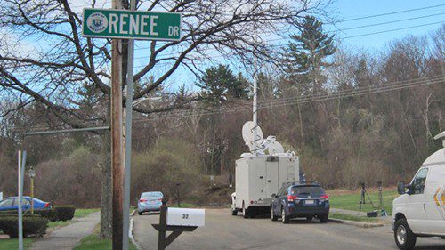 A MAN was found dead yesterday in a wooded area that extends beyond Sunset Drive. Access is by a dirt road located in front of the white satellite truck. (Gail Lowe Photo)