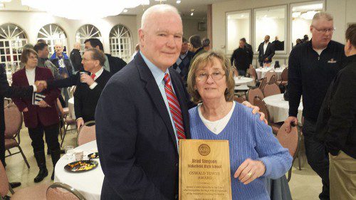 WMHS varsity boys’ basketball coach Brad Simpson (left) received the Oswald Tower Award recently at the IAABO 27 banquet. On the right is Simpson’s wife, Judy.