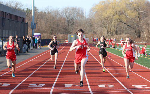SAM ROSS, a junior (middle), captured first in the 100 meter dash in a time of 14.1 seconds. Taking second was freshman Anna Lucas (left) in a time of 14.5 seconds. Freshman Hailey Lovell (right) also ran the event but didn’t place.     (Donna Larsson Photo)