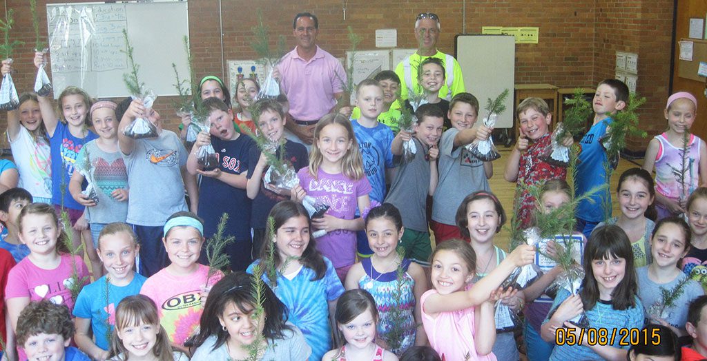 THE TOWN CELEBRATED Arbor Day last week and passed out fir seedlings to all third graders in the Woodville, Walton, Dolbeare and Greenwood schools. Close to 300 seedlings were distributed. Here, Forestry, Parks and Cemetery Supervisor Dennis Fazio (back left) and Mike Shannon of the Tree Department stand with students in Jean Maio's third grade class at the Walton School. 