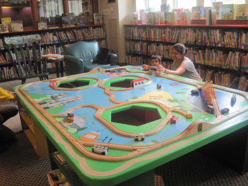 NEXT time you visit the Beebe Library make sure you visit the Youth Room to see the new train table. Artist Amy Janicki and carpenter Bob Surette have built a centerpiece that serves as a community gathering place that will delight and surprise families for years to come. The Rotary Club of Wakefield contributed the funds to bring this project to fruition. Shown at the new train table are Wakefield residents Shikha Singh and her son Sashnaank Singh, 15 months old. (Gail Lowe Photo)