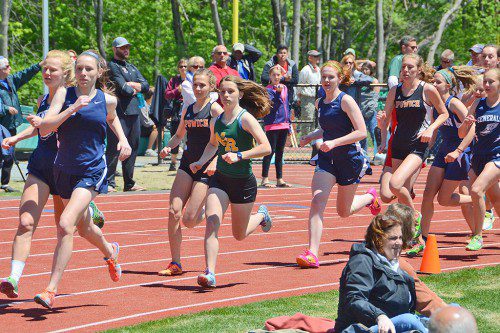 LYNNFIELD milers Kate Mitchell (front inside lane) and Marie Norwood (third from right inside lane) keep pace with the pack in the varsity CAL Championship meet Saturday. Mitchell (5:15) finished third and Norwood (5:35) took fifth overall. (John Friberg Photo)
