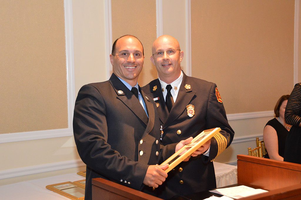 FIREFIGHTER OF THE YEAR.  North Reading's Vincent Zarella, (left), was honored by Chief William Warnock as the department's firefighter of the year at the Reading–North Reading Chamber of Commerce Outstanding Citizens Awards Ceremony. Zarella was selected for his leadership role in the department's "Retire the Fire" program. (Bob Turosz Photo)
