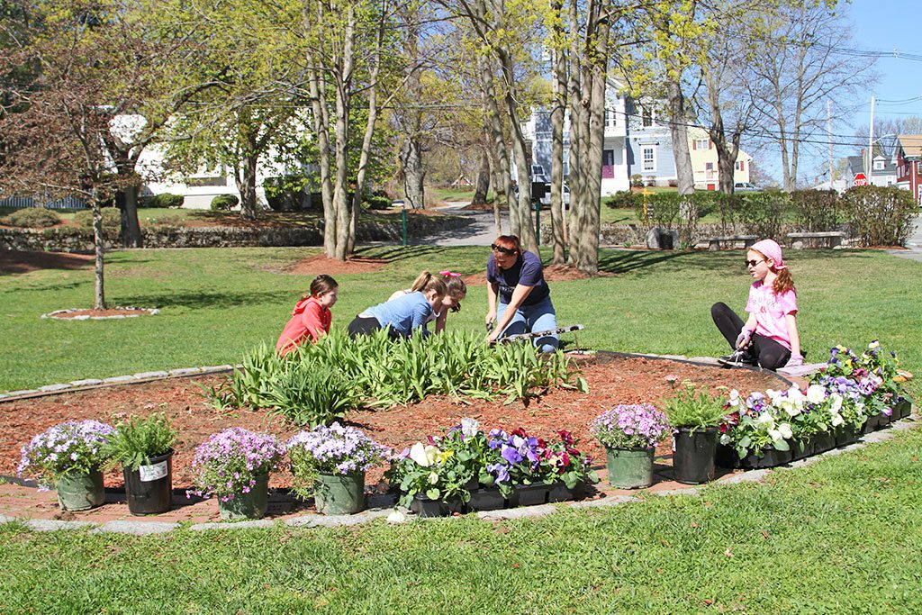 GIRL SCOUT TROOP 65419 does some planting in the Friendship Circle at Cedar Park during a beautiful weekend day. (Donna Larsson Photo) 