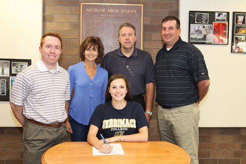 AMANDA CAIN, a standout libero on the league champ MHS volleyball team and member of the 2012 State Champion team, recently signed a letter of intent to play at Merrimack College. Pictured is Cain (sitting) and (left to right) head coach Scott Celli, mother Robin Cain, father Michael Cain and assistant coach Steve Wall. (Donna Larsson photo)