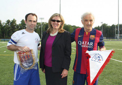 SCHOOL SUPERINTENDENT Jane Tremblay welcomed team captains Doug Prouty (left) of the Boston Braves and Jose Antonio Ramos Huete, known as Pepito, of F.C Barcelona, as they exchanged team flags prior to their soccer game at LHS. (Maureen Doherty Photo)