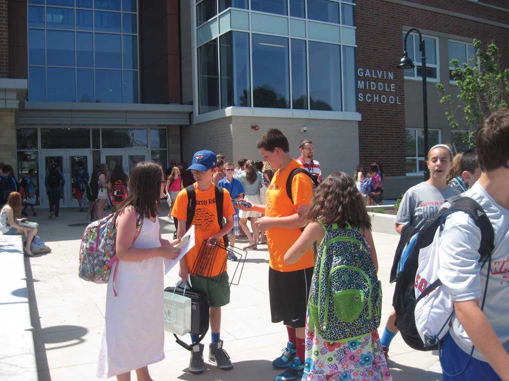 AS soon as the final bell rang at the Galvin Middle School yesterday, marking the close of the 2014-2015 academic year, students were seen streaming out of the school and mounting their bicycles and scooters. (Gail Lowe Photo)