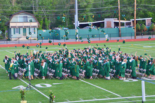 THE CLIMACTIC MOMENT. The Class of 2015 tosses their mortarboards in the air, making it official. They are now NRHS graduates. (John Friberg Photo)