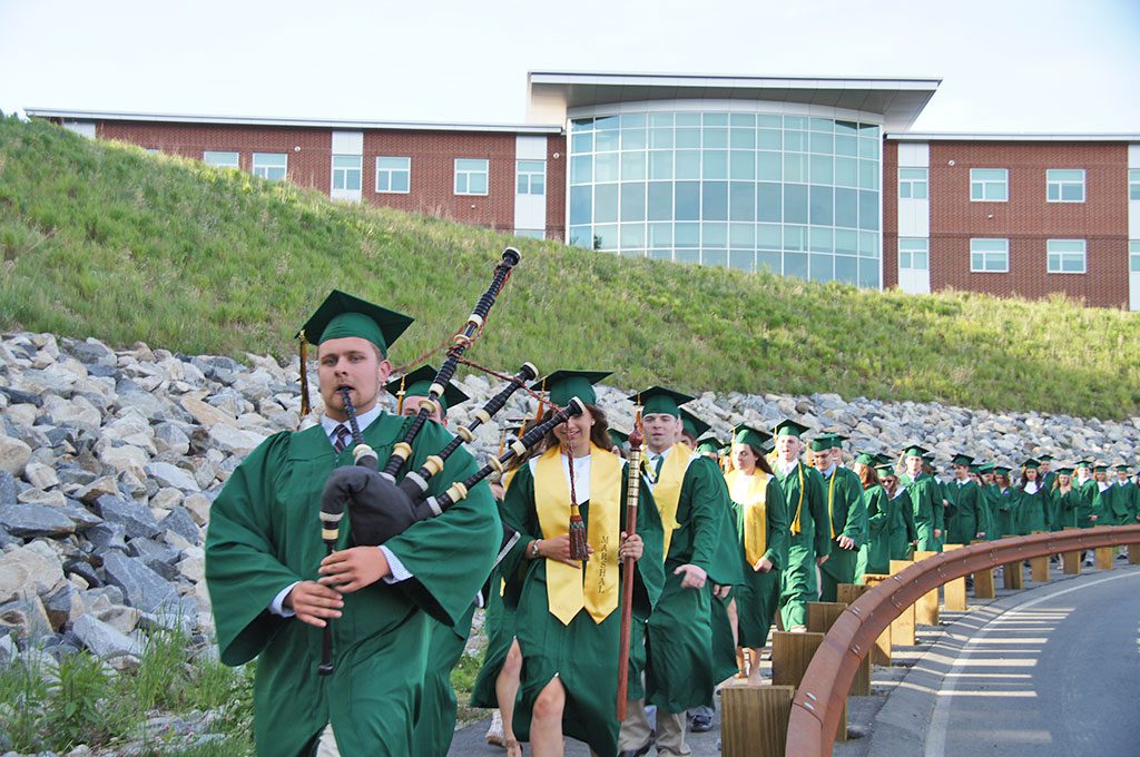 SENIOR TYLER SAMOST on the bagpipes, leads the Class of 2015 on the long march down the hill from the new high school for the start of NRHS Commencement Friday night. (John Intorcio Photo)