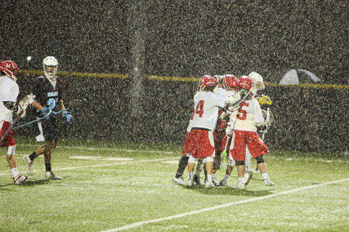 MOTHER NATURE couldn't keep the Melrose boy's varsity lacrosse team from beating Dracut 10-5 Monday night at Fred Green Field in the opening round of the MIAA Div. 2 playoffs. (Donna Larsson photo)