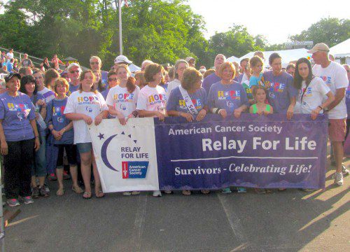 CANCER SURVIVORS and caregivers are ready to begin the Survivors Lap at the American Cancer Society’s 2015 Wakefield Relay for Life last Friday at the Northeast Metro Tech School field. The overnight event ended Saturday and drew hundreds of participants. (Mark Sardella Photo)