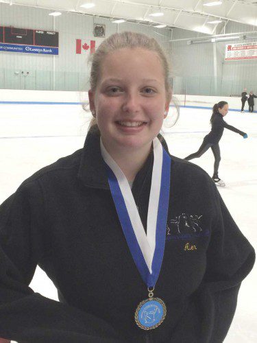 ALEX HATFIELD received a medal of achievement from the North Shore Skating Club for passing the last level, which is Free-skate 6. Hatfield has been a member of the skating club for eight years and performs in the yearly ice show. She received the medal showm from the Club director Suzi Sweezey.