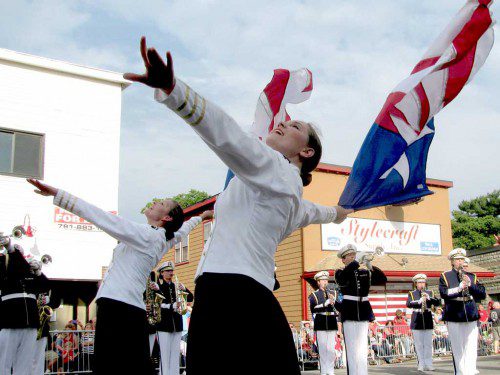 FLAG DANCERS from the Spirit of America Marching Band perform in front of the parade reviewing stand at the Americal Civic Center on Independence Day. (Mark Sardella Photo)