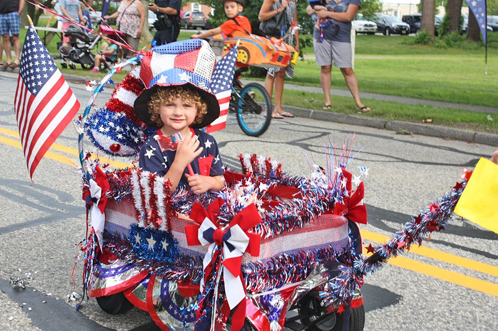 A BEDAZZLING display of red, white and blue in an Uncle Sam theme earned Chase Austin, 4, one of two awards for Best Float/Wagon in the annual Horribles Parade on the common sponsored by the Recreation Commission. (Maureen Doherty Photo)