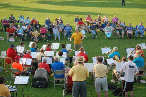 CONDUCTOR DON HODGKINS, founder of the Wakefield Summer Band, conducts Friday's opening concert with enthusiasm. The band's other performances will be July 24, Aug. 7 and 21 on the Lower Common. (Francis Hegarty Photo)