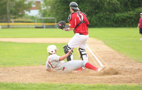 BRETT MALONEY slides in safely at home plate during a recent game. Maloney pitched five innings last night and earned the win for the Townies in an A division game in the Lou Tompkins All Star Baseball League. Wakefield beat the North End, 4-1. (Donna Larsson File Photo)