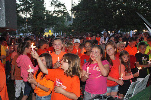 HUNDREDS of Sonny Tropeano's classmates and friends comforted one another during a candlelight vigil held in his honor on the common Thursday night. (Maureen Doherty Photo)