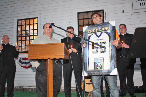NICK TROPEANO accepts the framed football jersey and photograph of his little brother, Sonny, presented to the family by Wayne Shaffer (left) on behalf of Lynnfield Youth Football. (Maureen Doherty Photo)