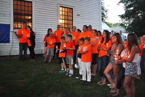 FAMILY and friends of 10-year-old Sonny Tropeano listened to the kind words and prayers offered during Thursday's candlelight vigil on the common attended by over 1,000 mourners. (Maureen Doherty Photo)