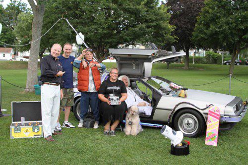 PREPARING TO TAKE A trip through time last night on the Common are (from the left): WCAT Executive Director Tom Stapleton; Patrick Shea, owner of the DeLorean Time Machine, and Nikki Baronas with the controls. Last night’s Movie By The Lake, hosted by WCAT, was “Back to the Future,” which is now 30 years old.      (Donna Larsson Photo)