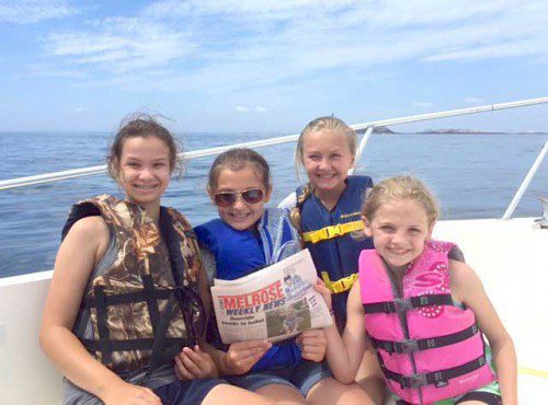 FOUR FRIENDS, on a summer break from the Roosevelt School, had a great time off the coast of The Isles of Shoals in New Hampshire recently. From the left are Kara Foucher, Chloe Gentile (holding a copy of the Weekly News), Juliet Moore and Grace Gentile. Chloe and Grace’s mom Jennifer is our sports editor.