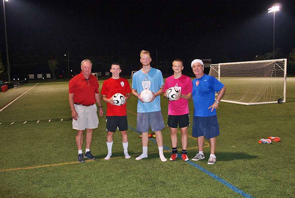 FORMER Wakefield High School Coach Dick Kelley and Coach Nick Padovani held their 20th soccer camp under the lights at the Galvin Middle School this week. From left, Kelley, 2015 senior captains Mark Melanson, Andrew Auld, Jonathan Ingalls and Padovani. (Courtesy Photo)