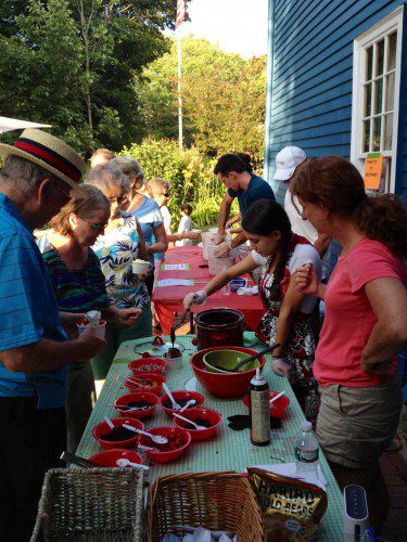 AN ice cream social was held last night at the Hartshorne House, drawing young and old alike. Toppings like hot fudge, whipped cream and crushed Oreo cookies were in abundant supply. Proceeds will be used for upkeep expenses of Wakefield's historic house. (Colleen Riley Photo)